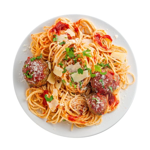 A plate of Celeno's Bistro spaghetti and meatballs, topped with tomato sauce, parmesan, and parsley.